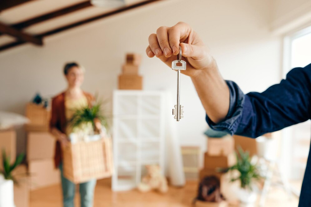 Hand holding keys for a new home by the top real estate agent in Laguna Niguel.