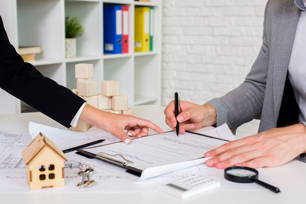 Top real estate agent in Mission Viejo reviewing paperwork with a client.